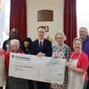 Volunteers of the Cayton Community Drop in receive cheque from Persimmon