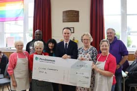 Volunteers of the Cayton Community Drop in receive cheque from Persimmon