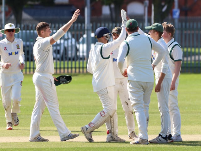 Flixton celebrate taking a wicket.