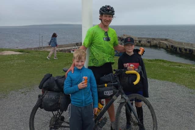 John Treacher, who cycled from Land's End to John O'Groats, pictured with his two children Eddie and James who met him at the finish line.