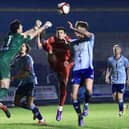 Michael Coulson challenges for the ball with the Ossett United keeper.