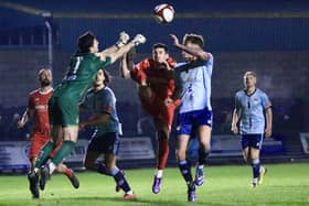 Michael Coulson challenges for the ball with the Ossett United keeper.