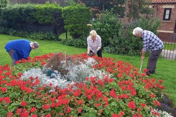 Volunteer gardeners at work on the Green, Ruswarp.