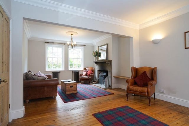 An open plan lounge and dining room, with a feature fireplace.