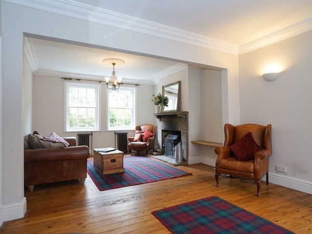 An open plan lounge and dining room, with a feature fireplace.