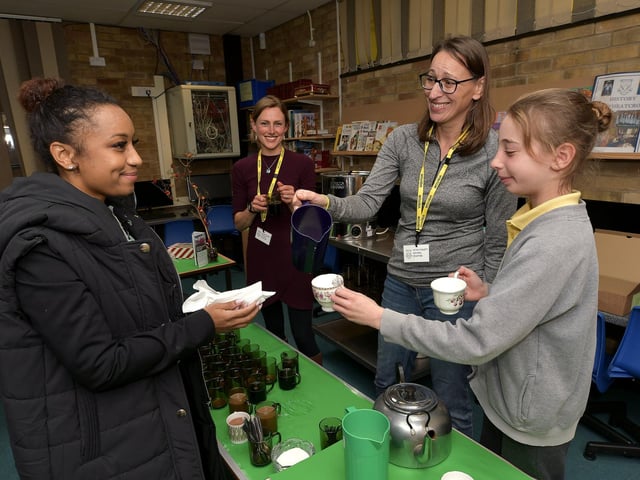 Sue Russell serves a customer with her daughter at the coffee morning