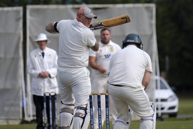 Darrol Lewis, Seamer, looks back anxiously as Flixton 2nds keeper Will Norman collects the ball