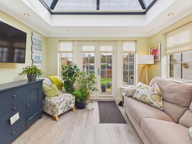 The lovely garden room has a lantern roof.