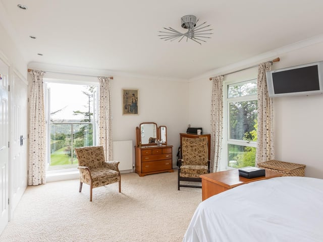 This double aspect bedroom is one of five bedrooms in the property.