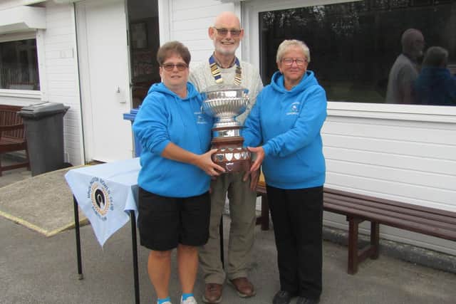 Pam Watson, right, and daughter Lisa are presented with the Association Rosebowl Doubles by chairman Ed McCormack.