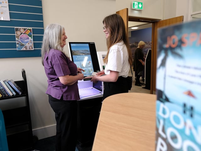 Fiona Bennet explaining the new booking stations.