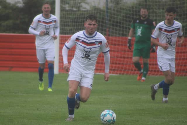 Sam Collins pushes on for Whitby Town.
