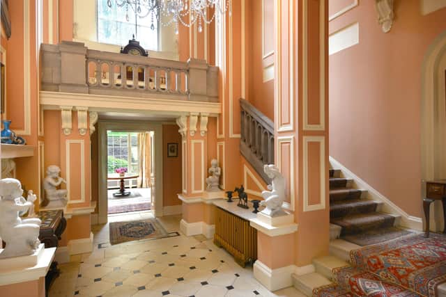 A hanging stone staircase and gallery landing are features within this impressive hallway.