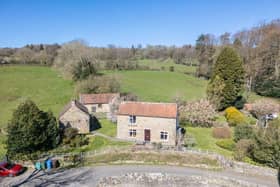 The traditional stone-built cottage has a lovely south-facing setting with views stretching over the River Esk.