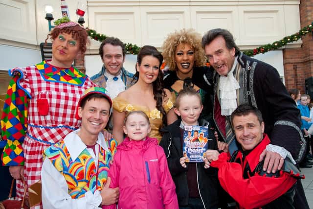 Raffle ticket winners Amber and Callum with the Brid Spa panto cast in 2012.