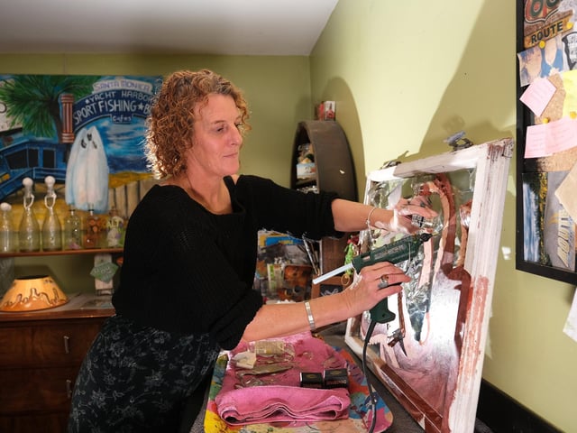 Filey artist Helen Randle working on her latest piece with broken glass