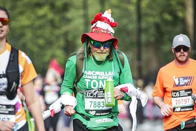 Robinson at the London marathon with seagulls on his arm and hat.