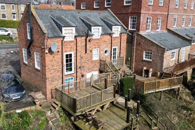 The Stables has extensive decking with access to the River Esk below.