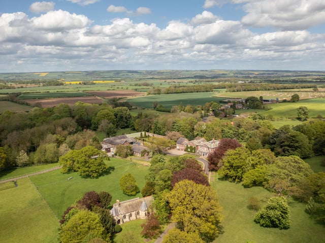 St Edmund's Church is seen in the foreground of this photograph looking over the Hall and grounds to the Yorkshire wolds beyond.
