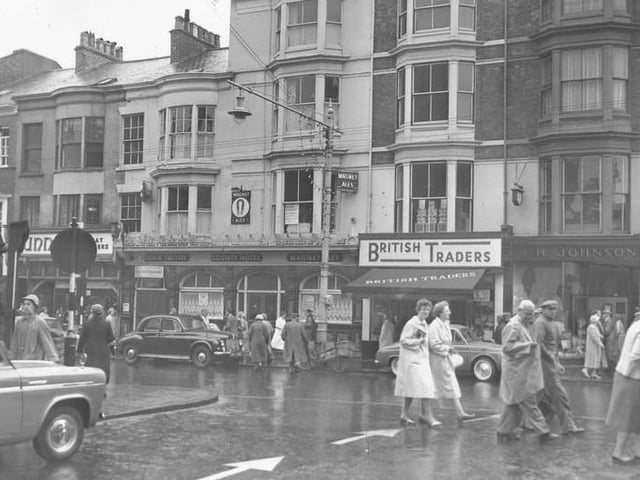 The County Hotel, next to British Traders, with an old tram post outside it.