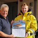 Whitby RNLI Museum curator Neil Williamson with volunteer crew member Andy Brighton who features on the June page of the calendar.
picture: RNLI/Ceri Oakes
