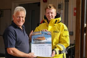 Whitby RNLI Museum curator Neil Williamson with volunteer crew member Andy Brighton who features on the June page of the calendar.
picture: RNLI/Ceri Oakes