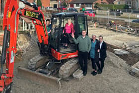 Brenda Asher, 90, a resident of Whitby's Peregrine House, clambers into the digger.
