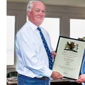 Cole Ibbotson (right) presented with his Service Certificate by Chief Exec Mark Dowie (left) at Flamborough RNLi station.