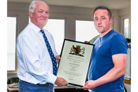 Cole Ibbotson (right) presented with his Service Certificate by Chief Exec Mark Dowie (left) at Flamborough RNLi station.
