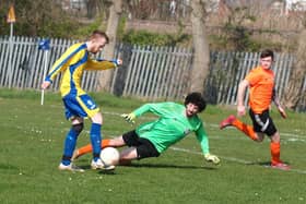 Filey's Joe Gage rounds the Snainton keeper