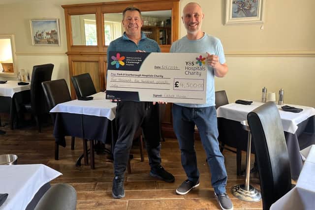 The owners of Estbek House, Sandsend, with their donation for the appeal.