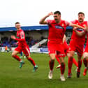 Will Thornton points to his head as he celebrates his injury-time leveller at Chester with his Boro teammates. PHOTOS BY ZACH FORSTER