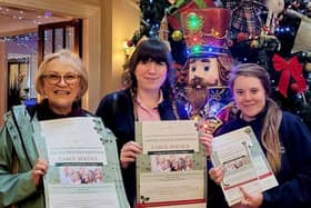 Volunteer Lori and activity members Skigh and Jess head out around town to distribute posters.