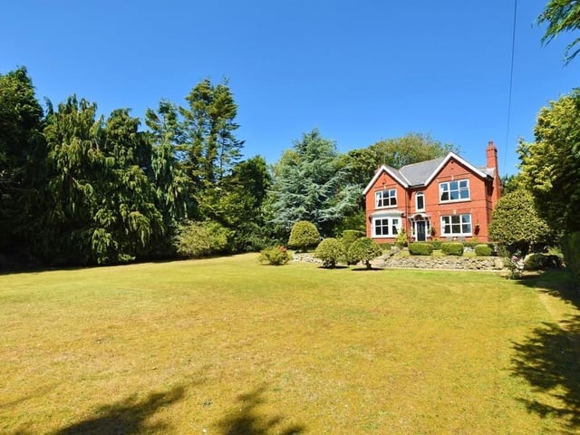 This detached grand residence is set in beautiful grounds with extensive lawns at both the front and rear of the property