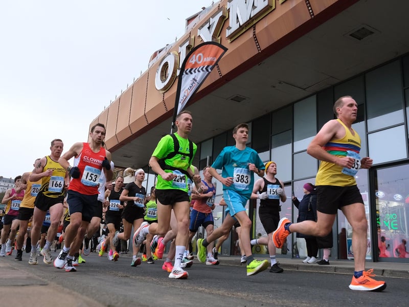 Runners pass Olympia amusements.