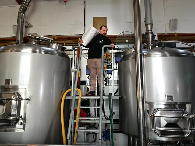 Max Jackson working in the brewery preparing the tanks.