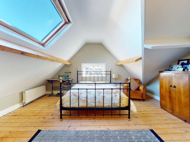 One of the upper floor bedrooms within the house.