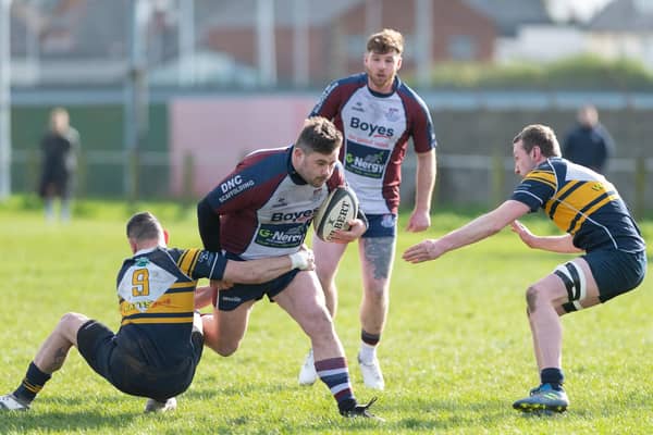 Billy Parker looks to evade a couple of Brid players. PHOTOS: ANDY STANDING