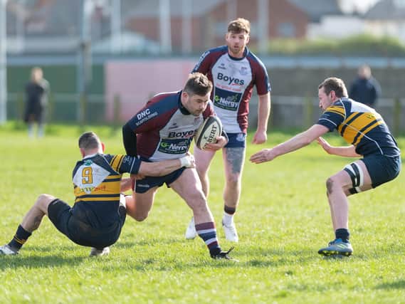 Billy Parker looks to evade a couple of Brid players. PHOTOS: ANDY STANDING