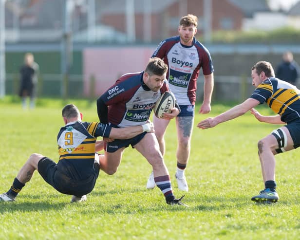 Billy Parker looks to evade a couple of Brid players. PHOTOS: ANDY STANDING