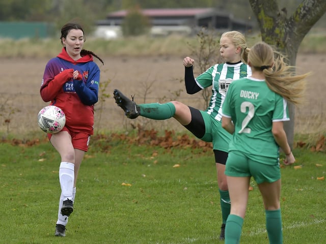 Midfielder Milly Walker goes in for a challenge with a Wigginton player