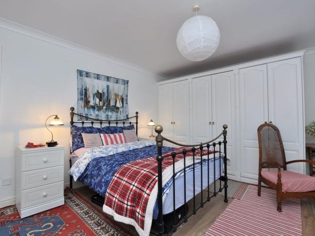One of the property's double bedrooms with fitted furniture.