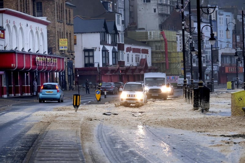 Vehicles pass along Foreshore Road.