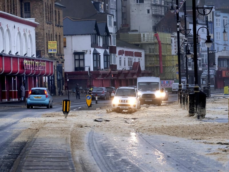 Vehicles pass along Foreshore Road.
