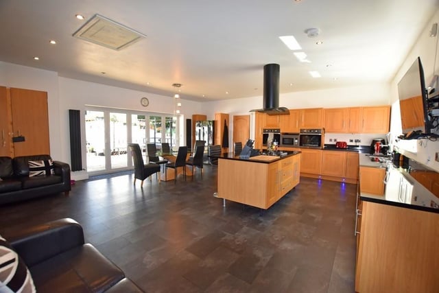 There is a large entertaining living kitchen diner with plenty of space and storage