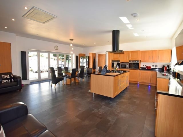 There is a large entertaining living kitchen diner with plenty of space and storage
