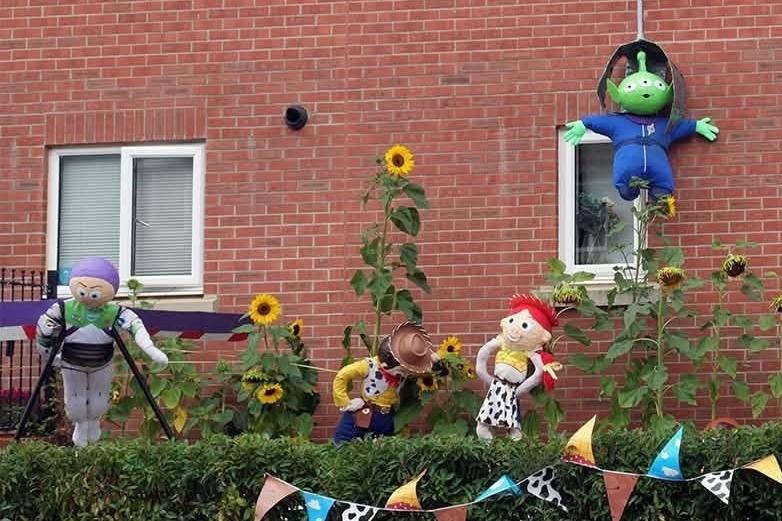 Toy Story characters amongst the sunflowers.