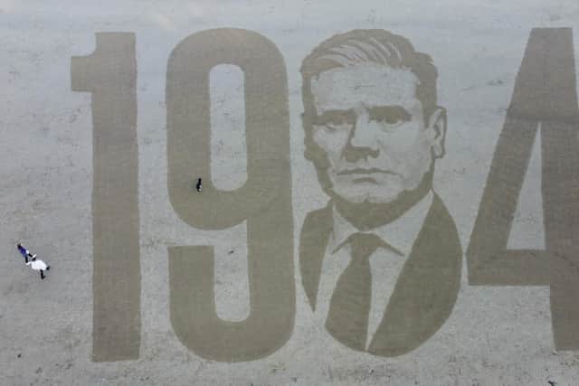 Artist Fred Brown spent three hours etching the massive 50m wide design into the sand on Scarborough beach.