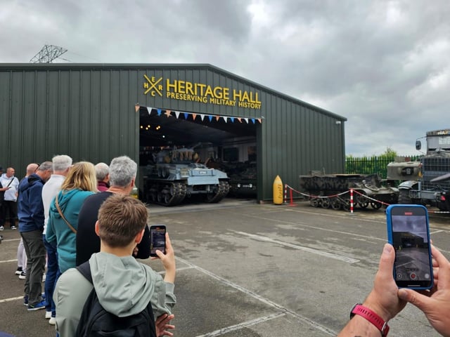 Visitors film as the Sherman M50 leaves the Heritage Hall