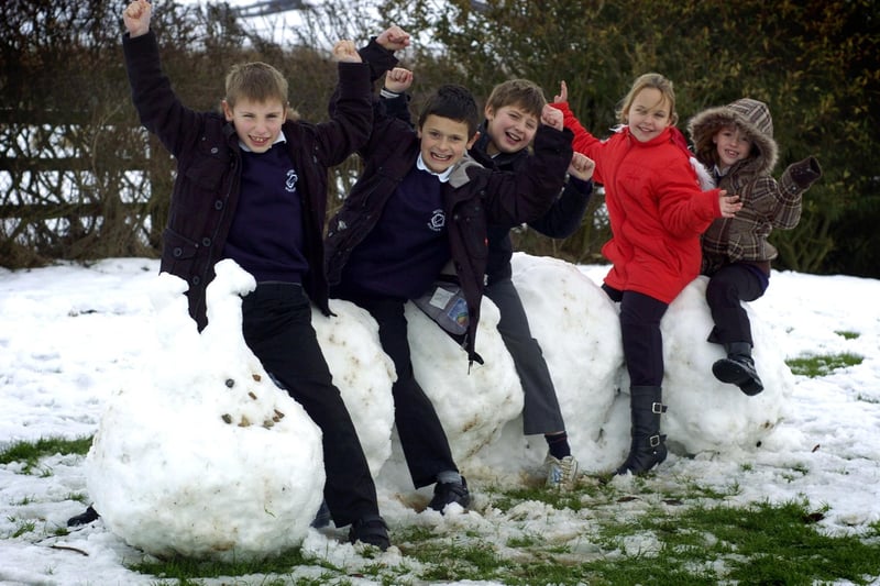 Snow creations at Seton Primary School, Staithes. Pupils are pictured seated on a snow caterpillar they have made.
